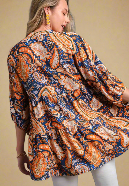 Woman wearing a patterned shirt with a beige background