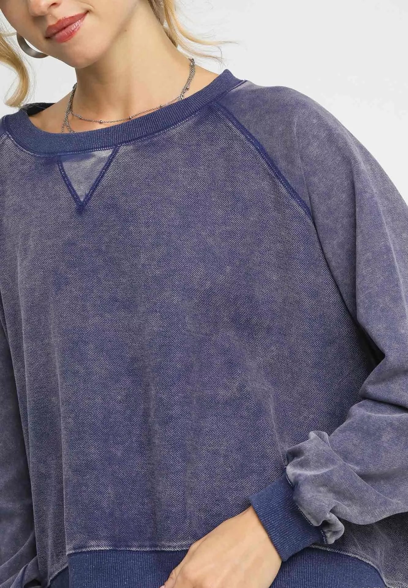 Navy blue sweatshirt worn by a person on a white background