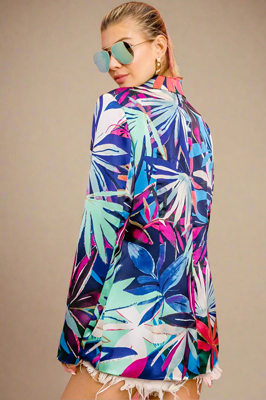 Woman wearing a colorful tropical pattern dress with balloons in the background