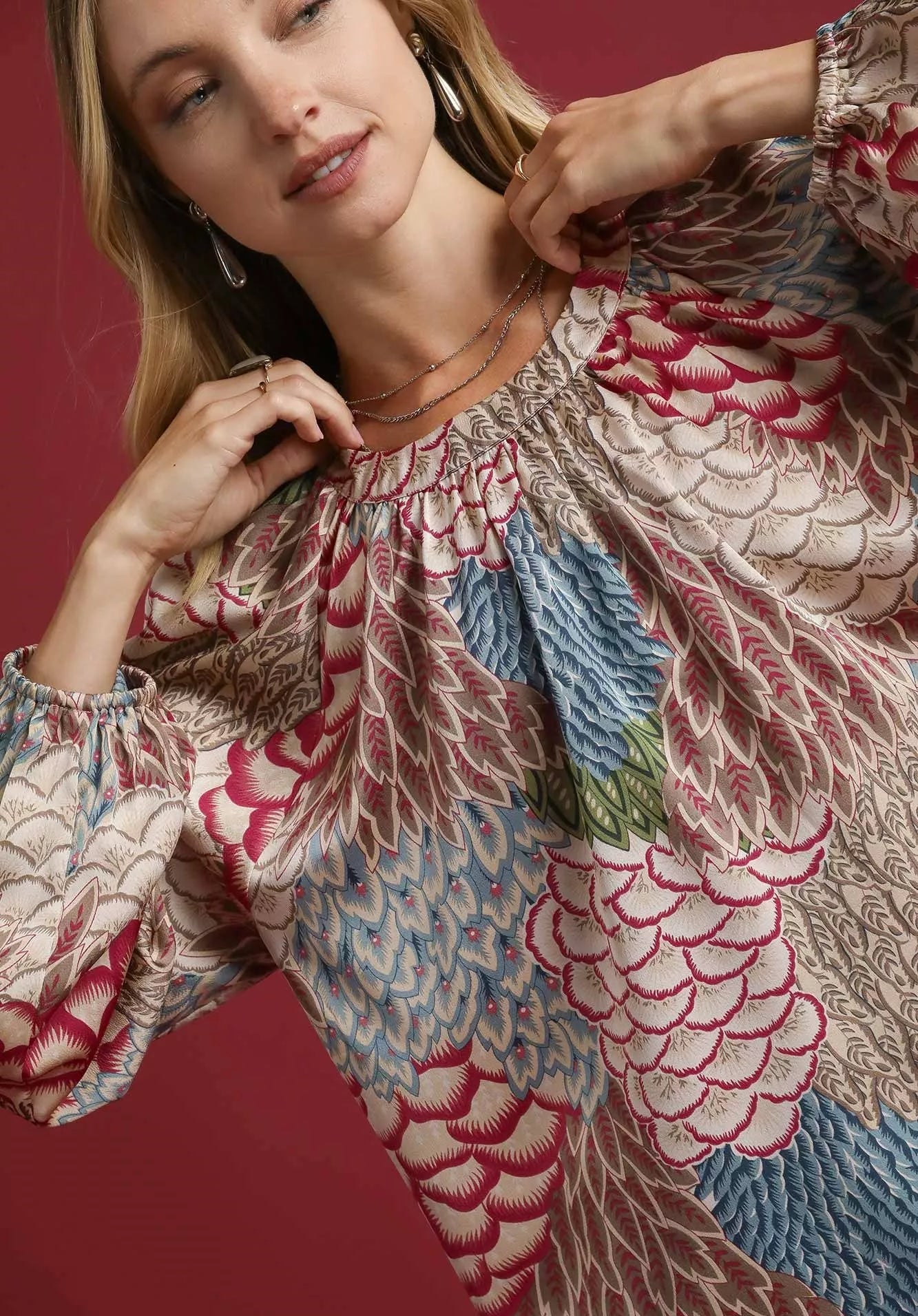 Woman wearing a floral embroidered dress with a brown background