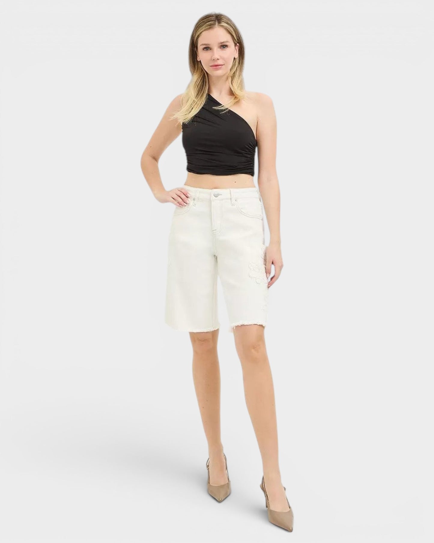 Beach Rose Co. ivory denim Bermuda shorts with tone-on-tone floral embroidery and raw hem. Made of cotton and spandex.