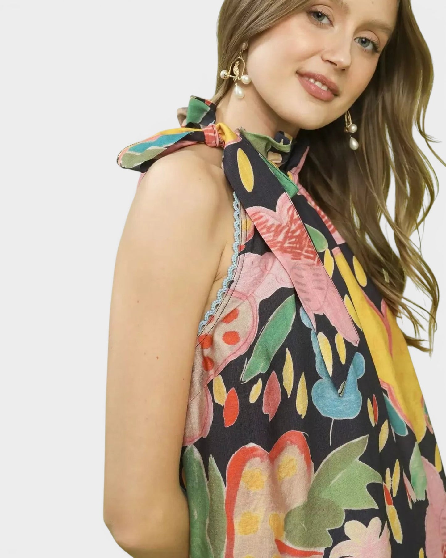 Beach Rose Co. navy halter top with colorful floral print, tie-back detail, and crochet trim. Rayon-nylon blend.