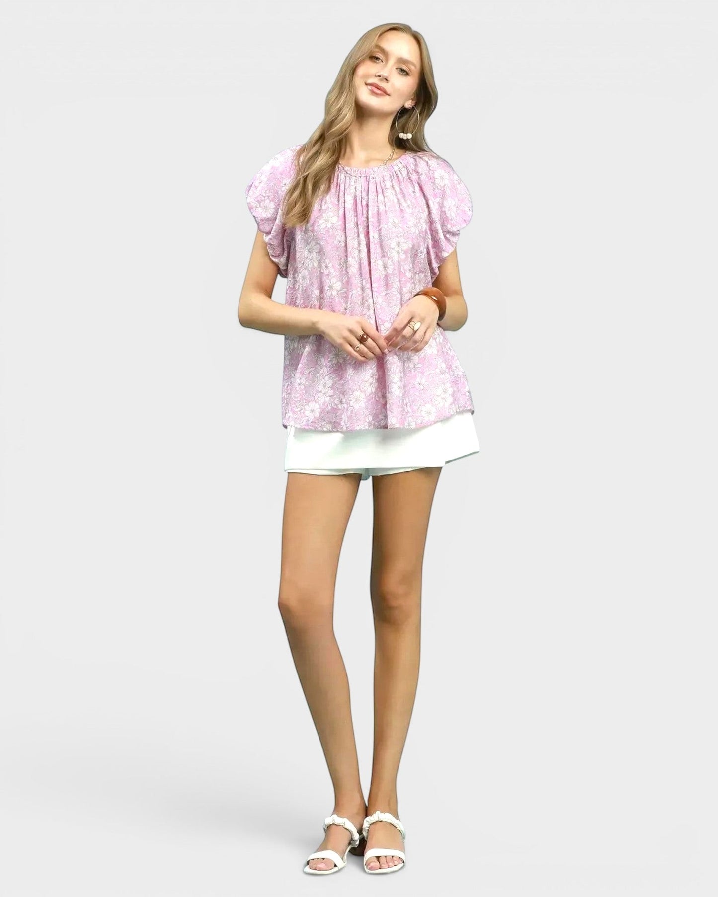 Beach Rose Co. pink floral puff sleeve blouse with gathered neckline and back keyhole detail. Made of rayon and nylon.