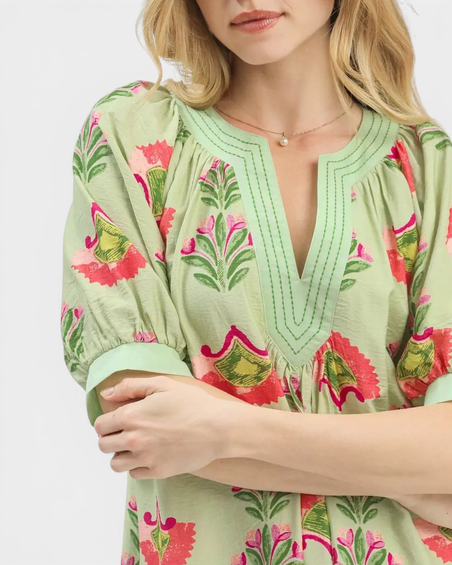 Beach Rose Co. sage floral mini dress with pink, green, and coral print, split V-neck, and puff sleeves.