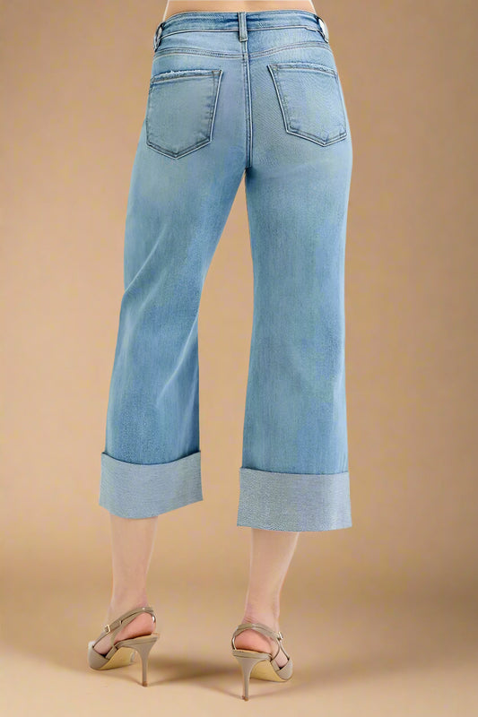 Light blue jeans worn by a person on a white background