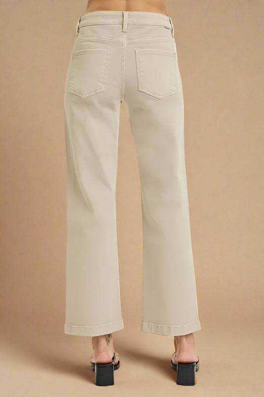 Beige pants worn by a person on a beige background