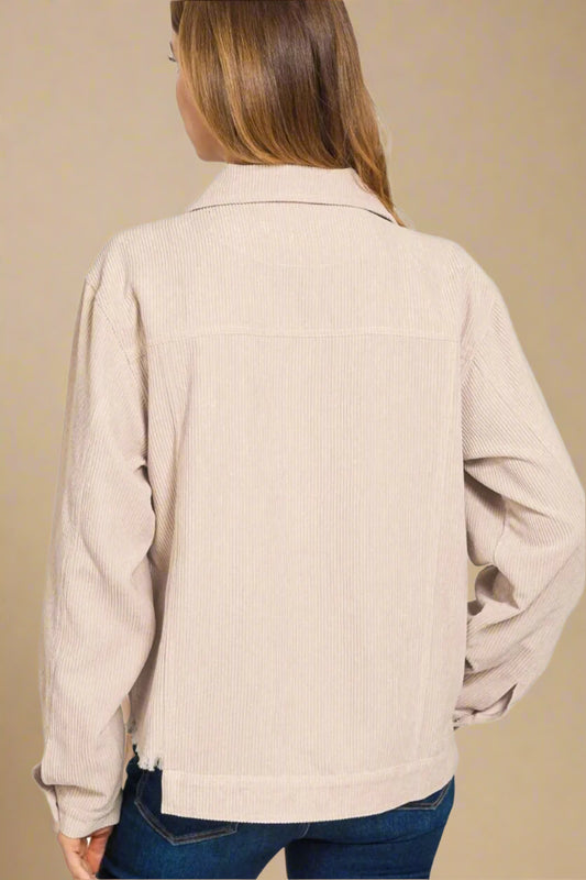 Beige corduroy jacket worn by a person on a white background