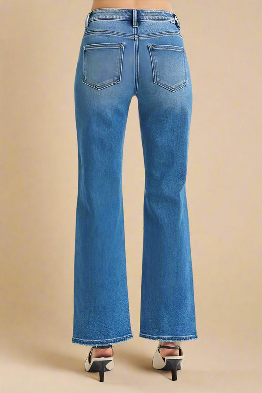 Blue jeans worn by a person on a white background