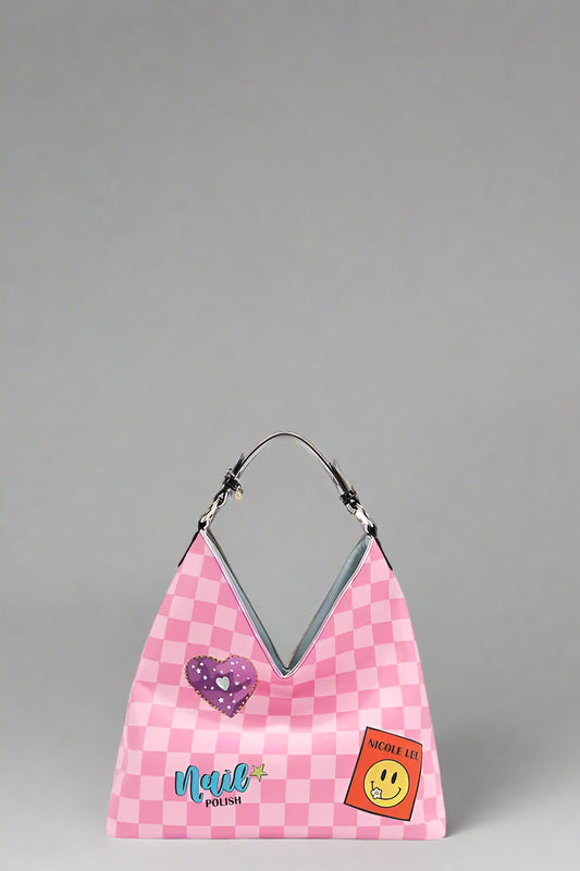 Pink checkered bag with heart and smiley face patches on a white background