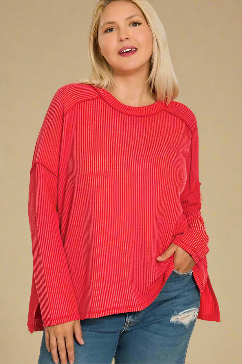 Woman wearing a red sweater and blue jeans on a white background