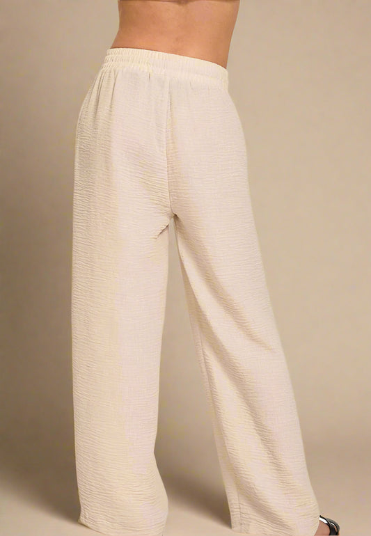 Beige wide-leg pants on a beige background