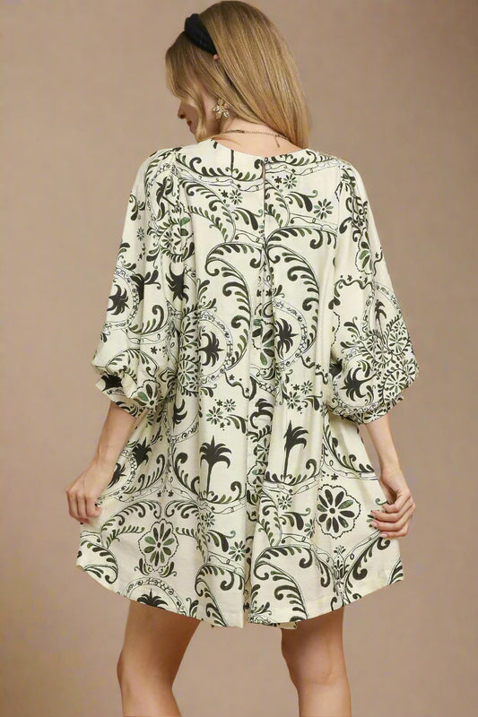 Woman wearing a patterned dress on a beige background