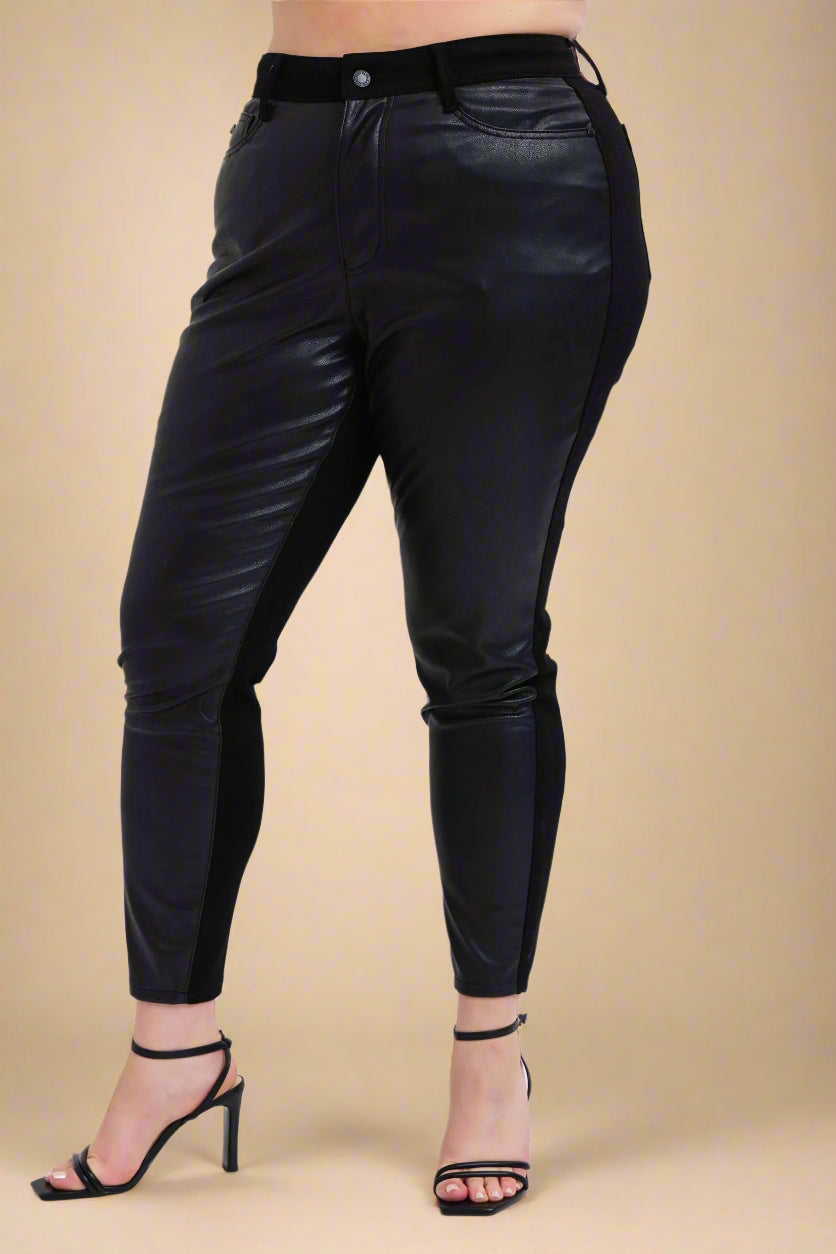 Black leather pants worn by a person on a white background
