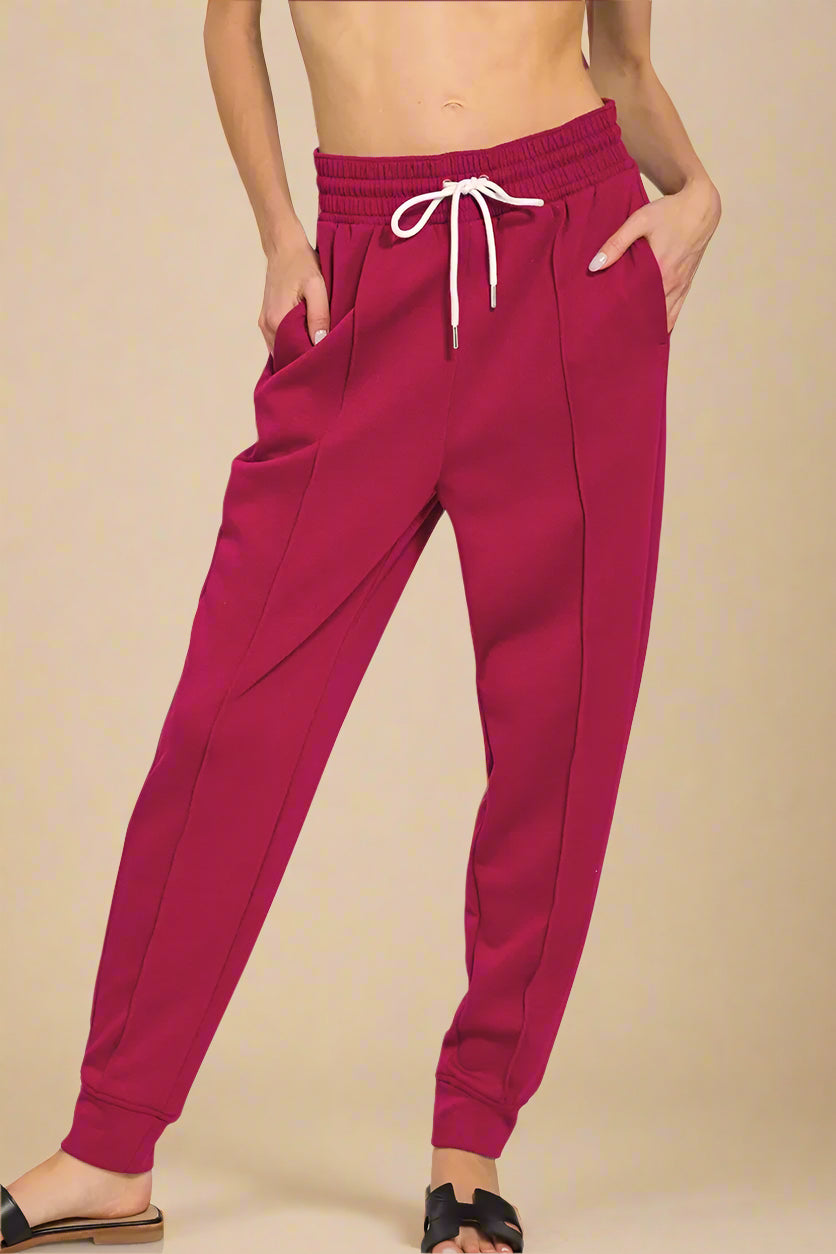 Cabernet purple jogger pants with a drawstring on a white background