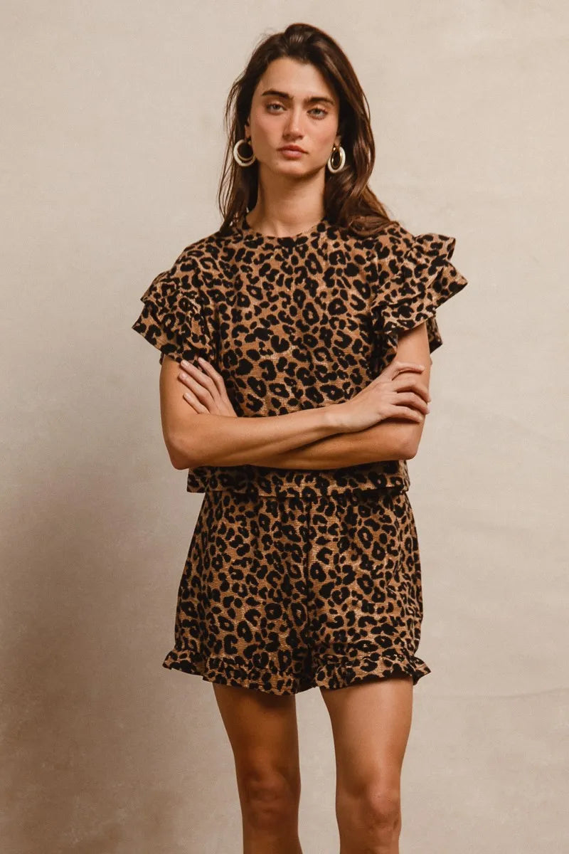 Woman wearing a leopard print dress against a beige background