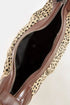 Leopard print clutch bag with a brown interior on a light beige background