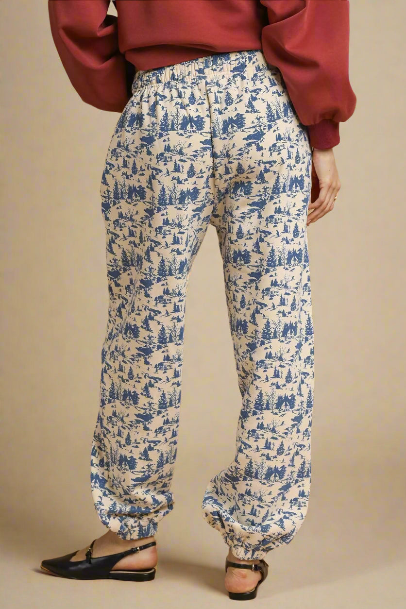 Blue patterned pants worn by a person on a beige background