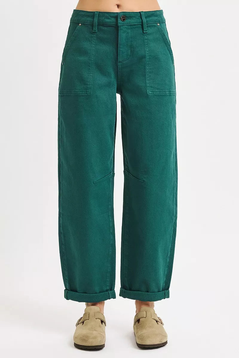 Green pants worn by a person on a white background