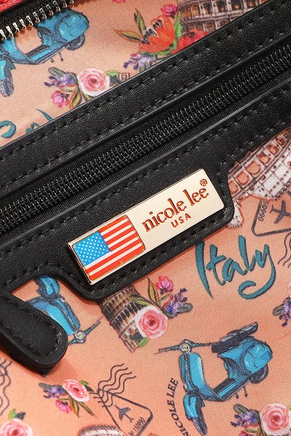 Close-up of a black zipper with a 'nicole lee' label on a patterned background.