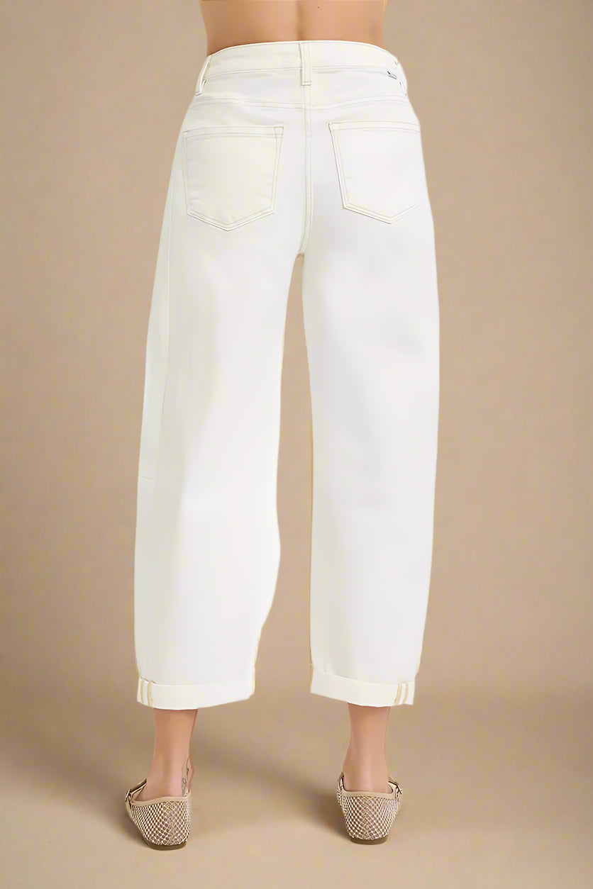 White jeans worn by a person on a white background