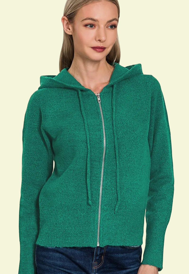 Woman wearing a green hoodie on a beige background