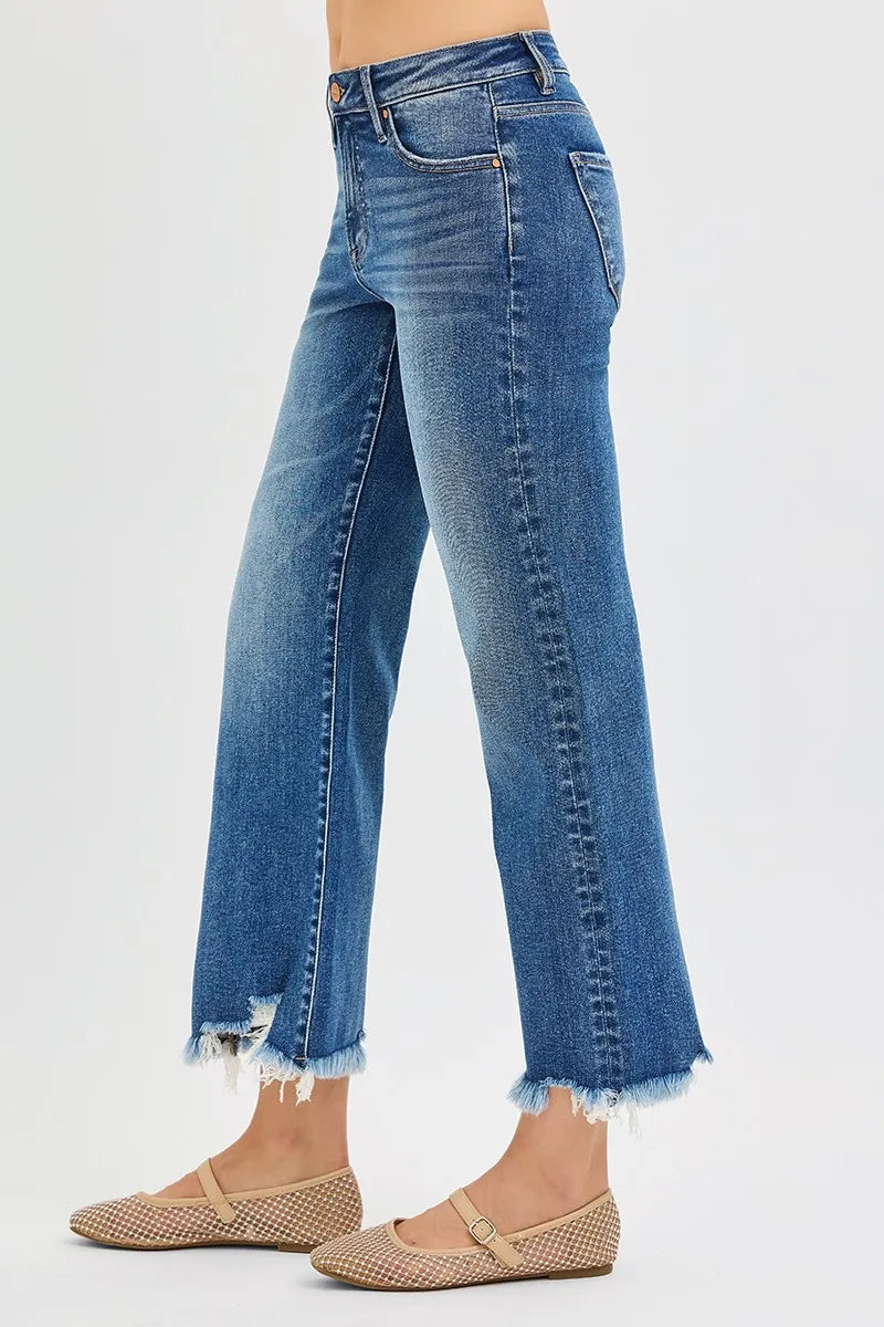 Blue jeans with frayed hems on a white background