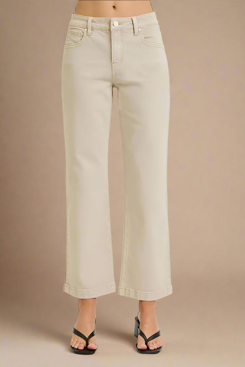 Beige wide-leg pants worn by a person on a beige background