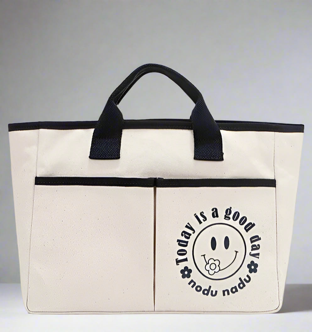 Beige tote bag with black handle and 'Today is a good day' text on a white background