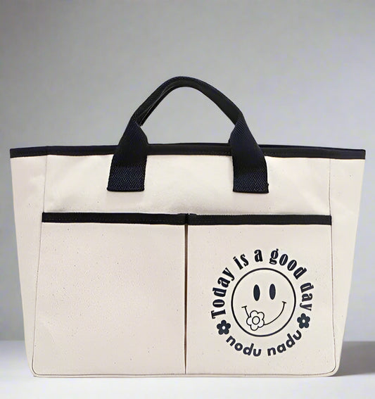 Beige tote bag with black handle and 'Today is a good day' text on a white background