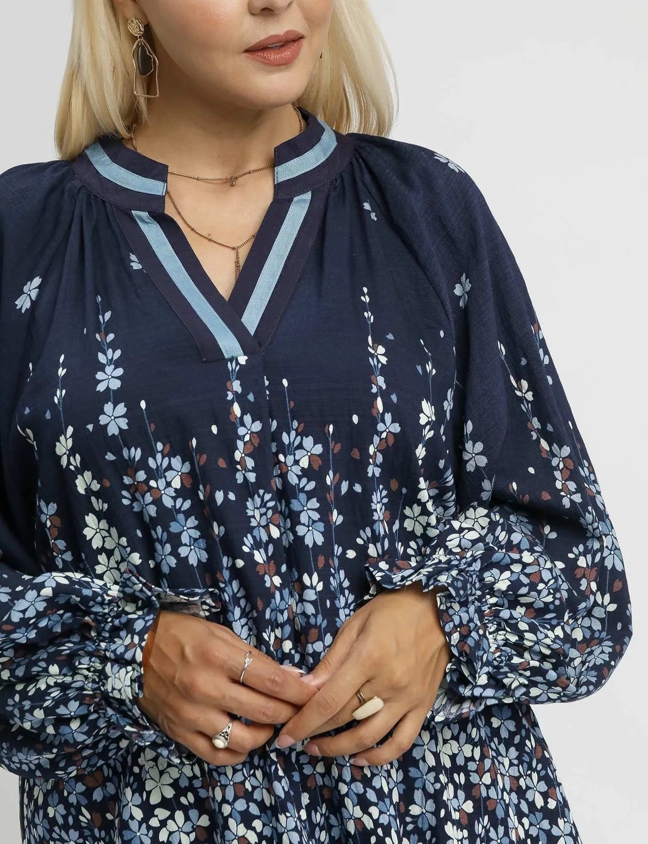 Woman wearing a navy floral blouse