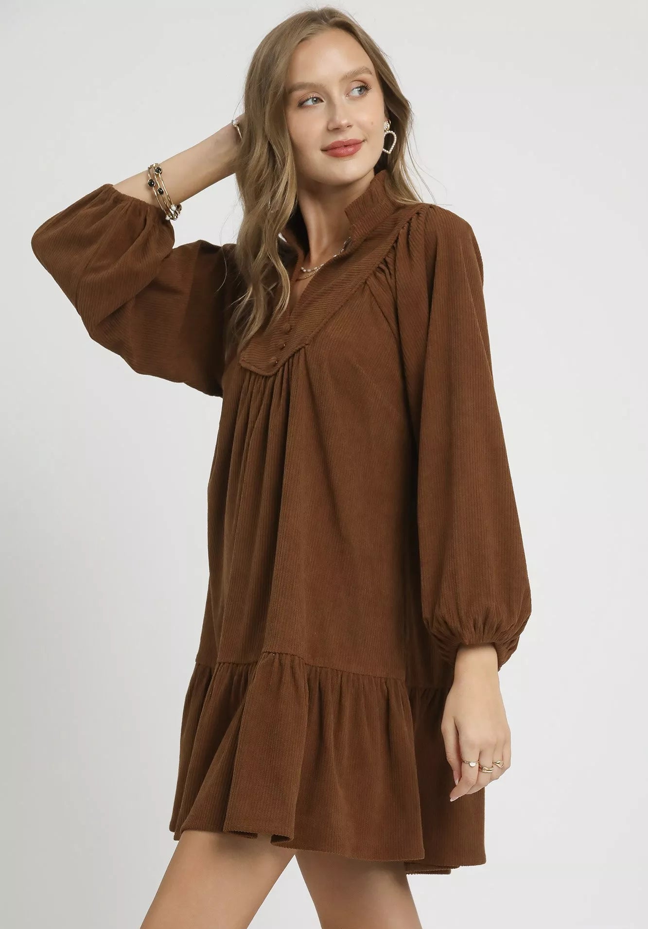 Woman wearing a brown dress on a white background