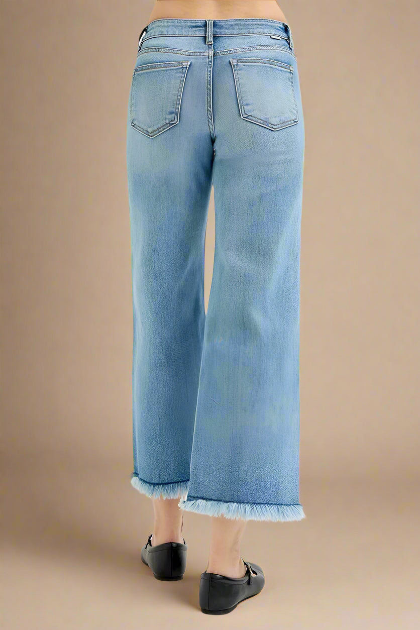 Light blue jeans worn by a person on a white background