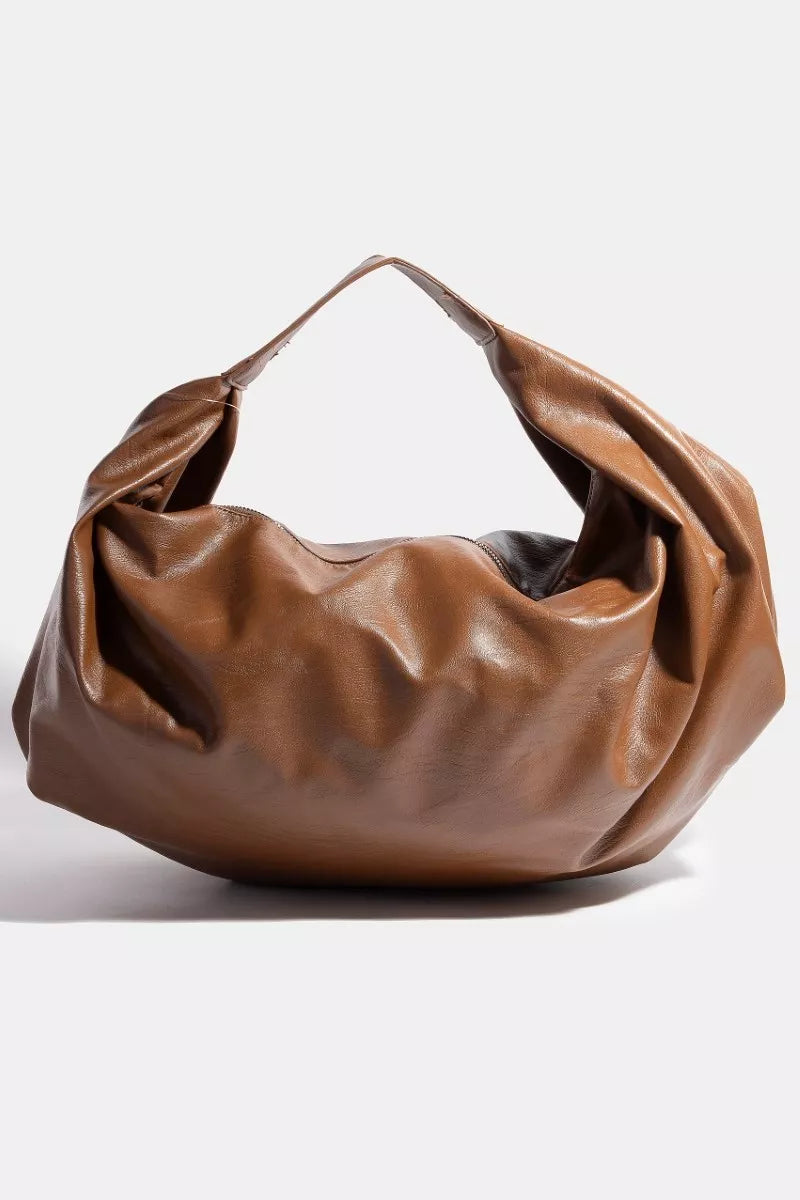 Brown leather handbag on a white background
