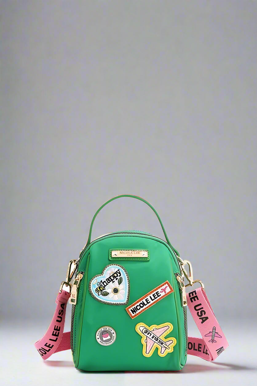 Green backpack with colorful patches and straps on a white background