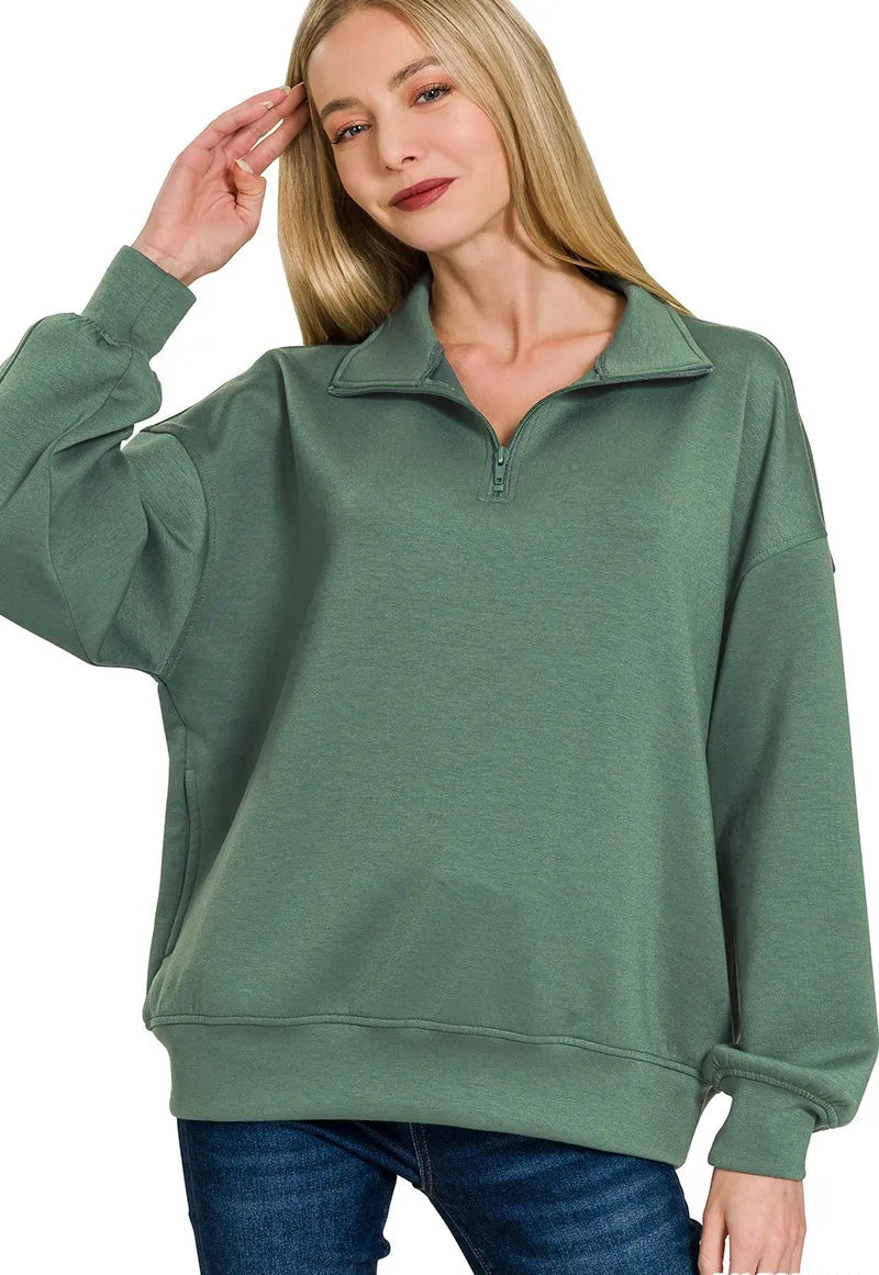 Woman wearing a green pullover with a white background