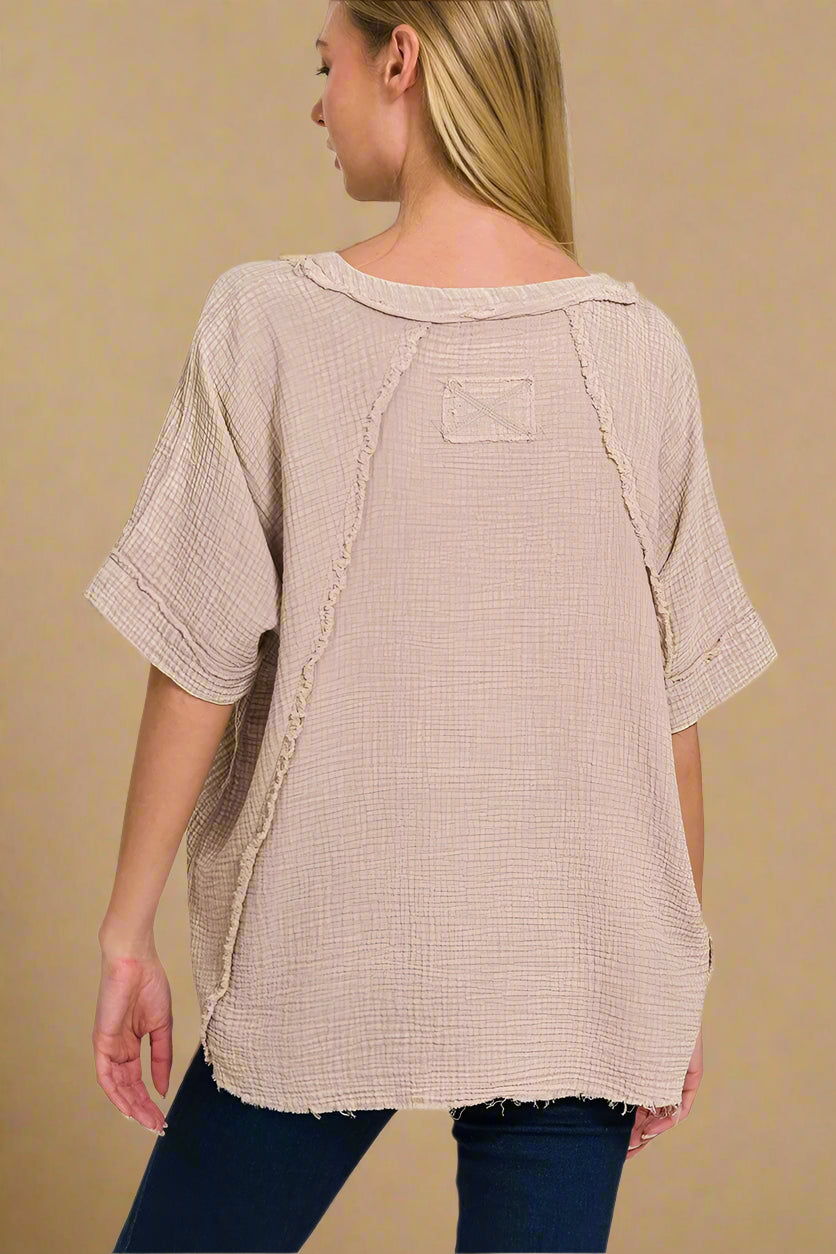 Woman wearing a beige textured top  on a white background