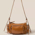 Brown leather handbag with multiple pockets and zippers on a beige background