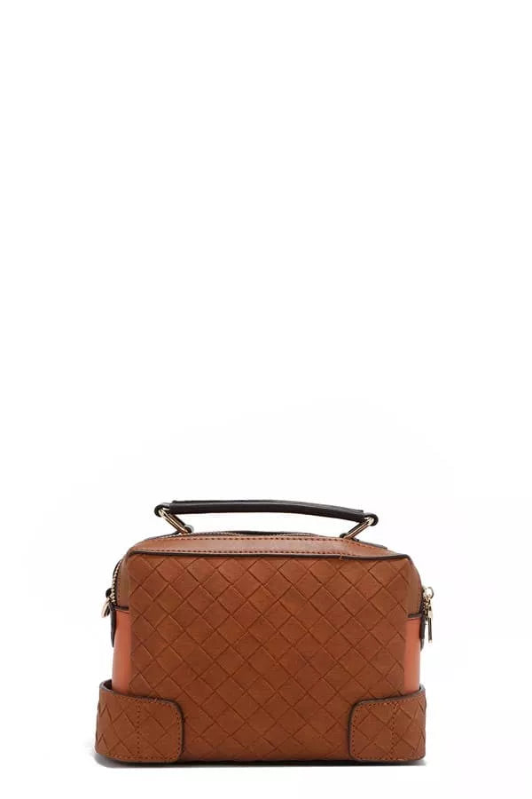 Brown quilted handbag on a white background