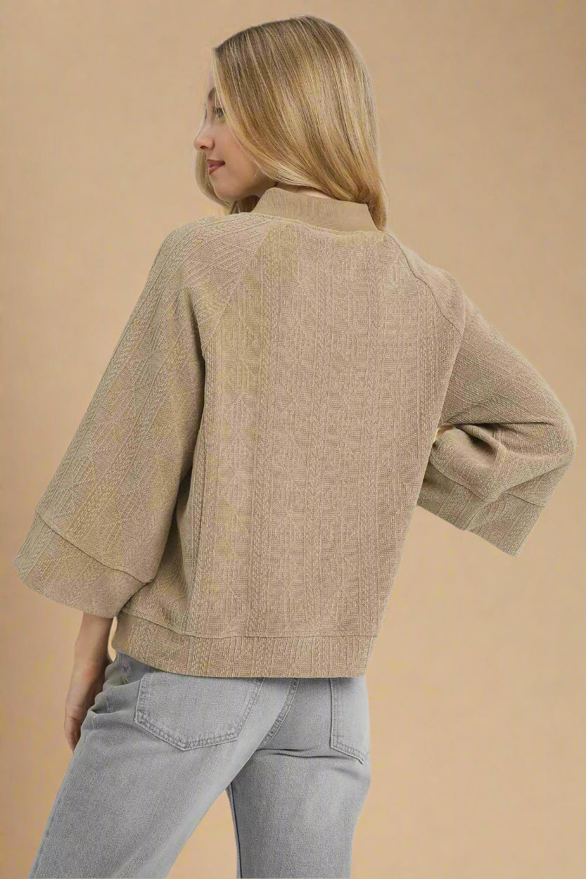 Woman wearing a beige top on a white background