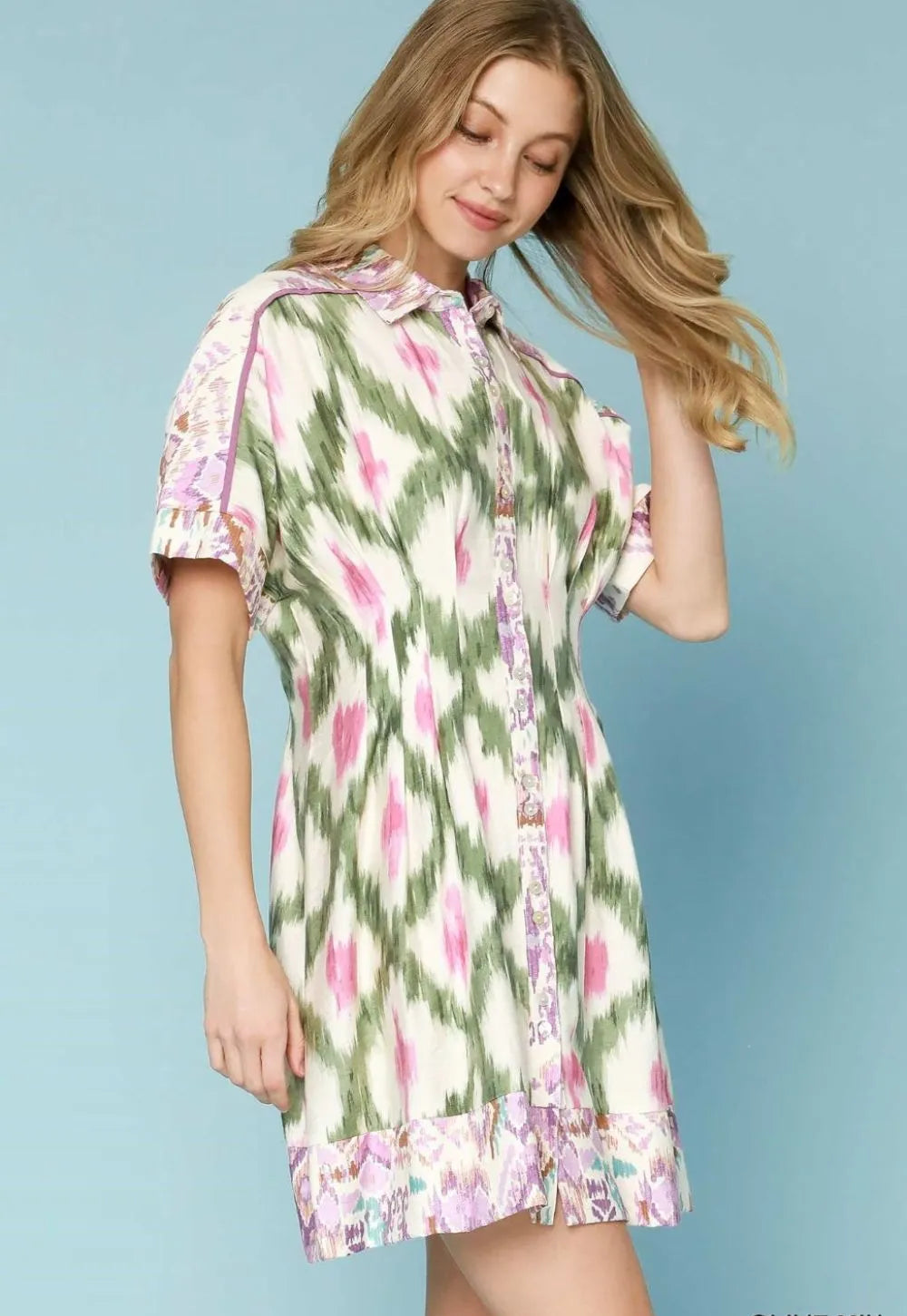 Woman wearing a floral dress against a light blue background