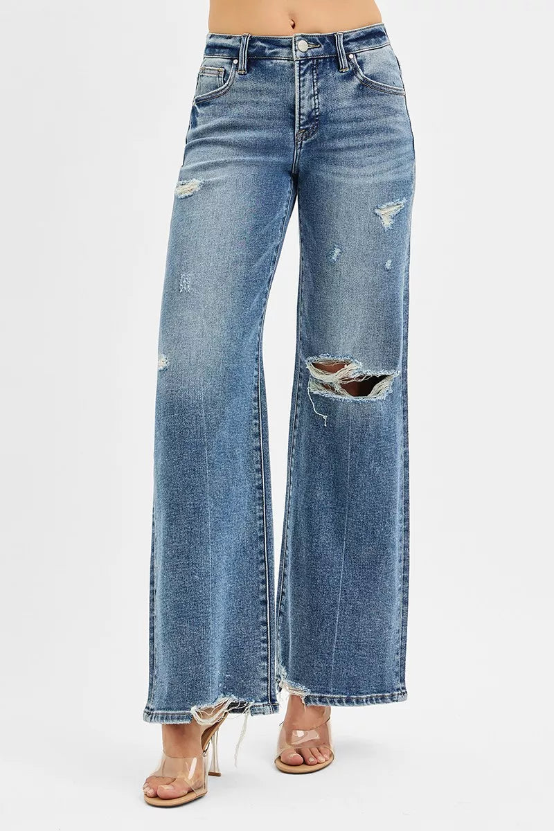 Distressed blue jeans on a white background