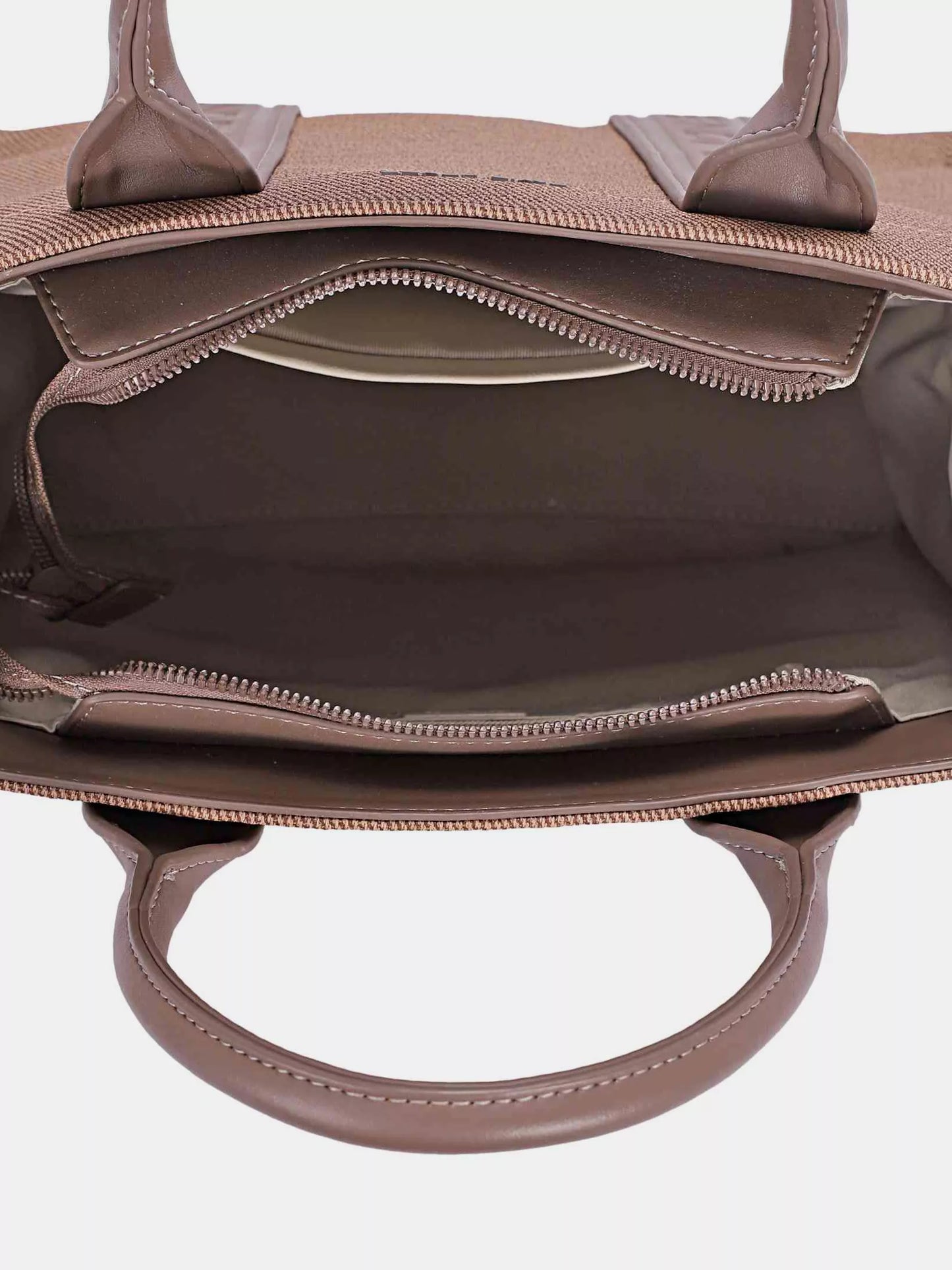 Close-up of a brown handbag with visible stitching on a white background