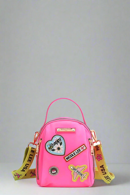 Pink backpack with colorful patches and straps on a white background
