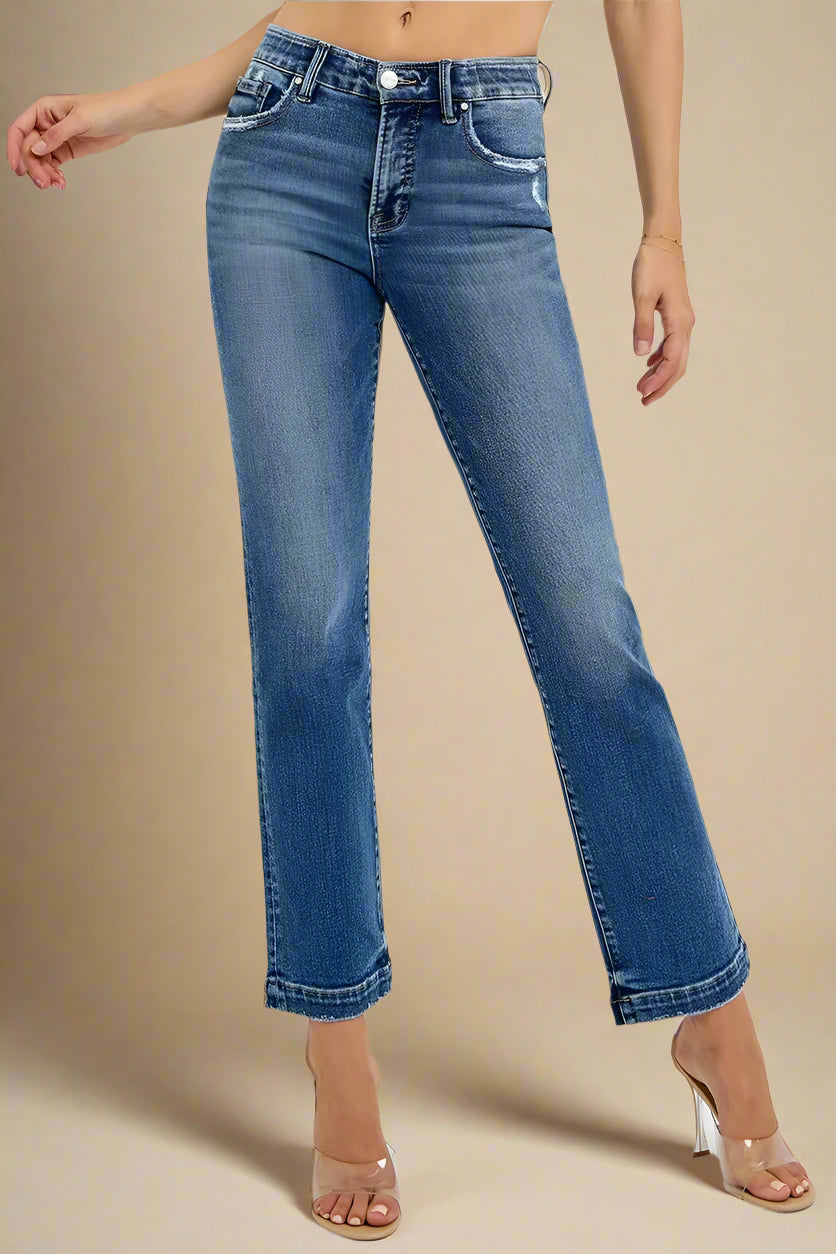 Blue jeans worn by a person on a white background