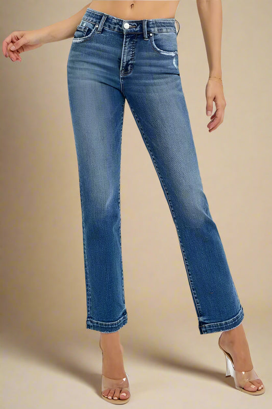 Blue jeans worn by a person on a white background