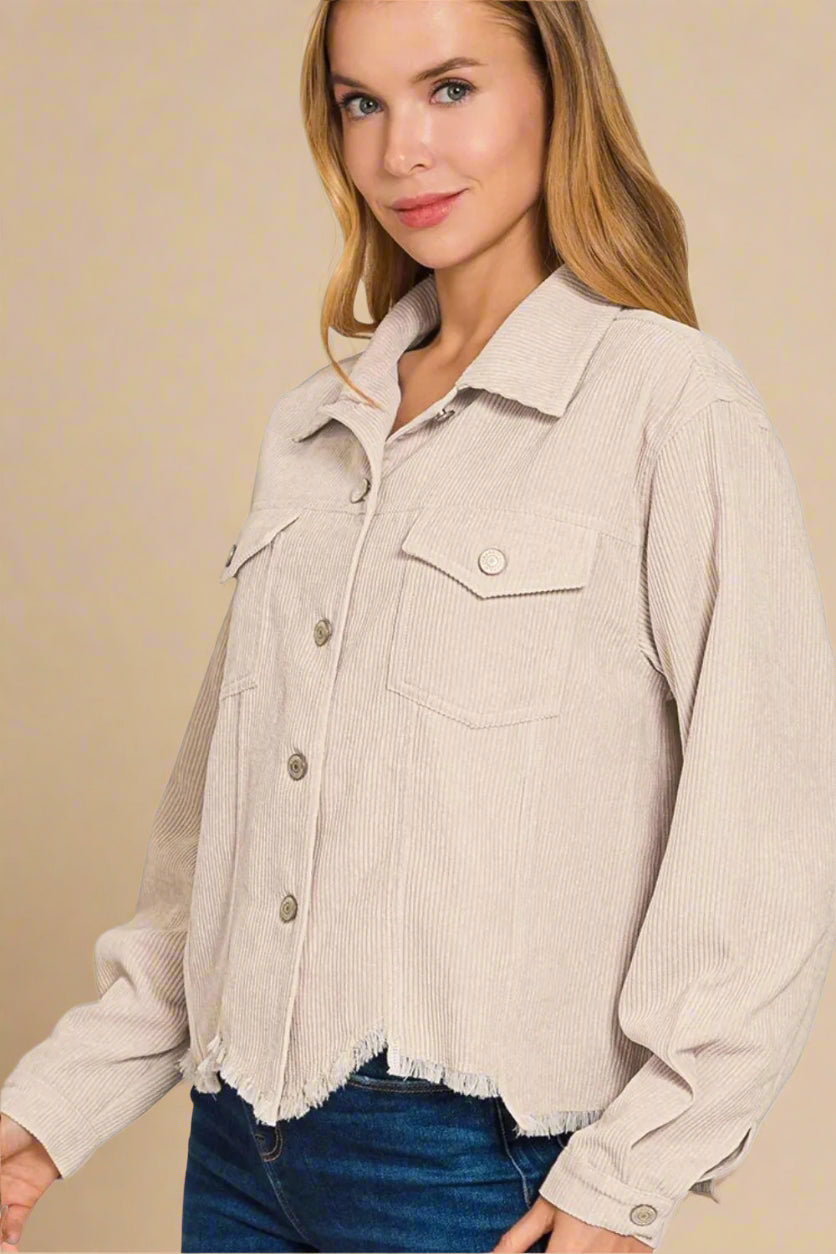 Woman wearing a beige corduroy jacket on a white background