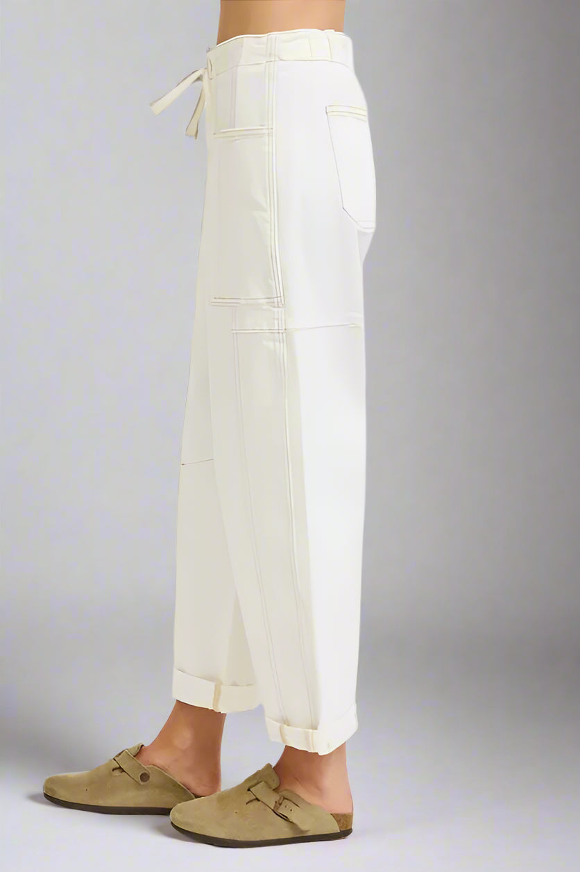 White pants worn by a person on a white background