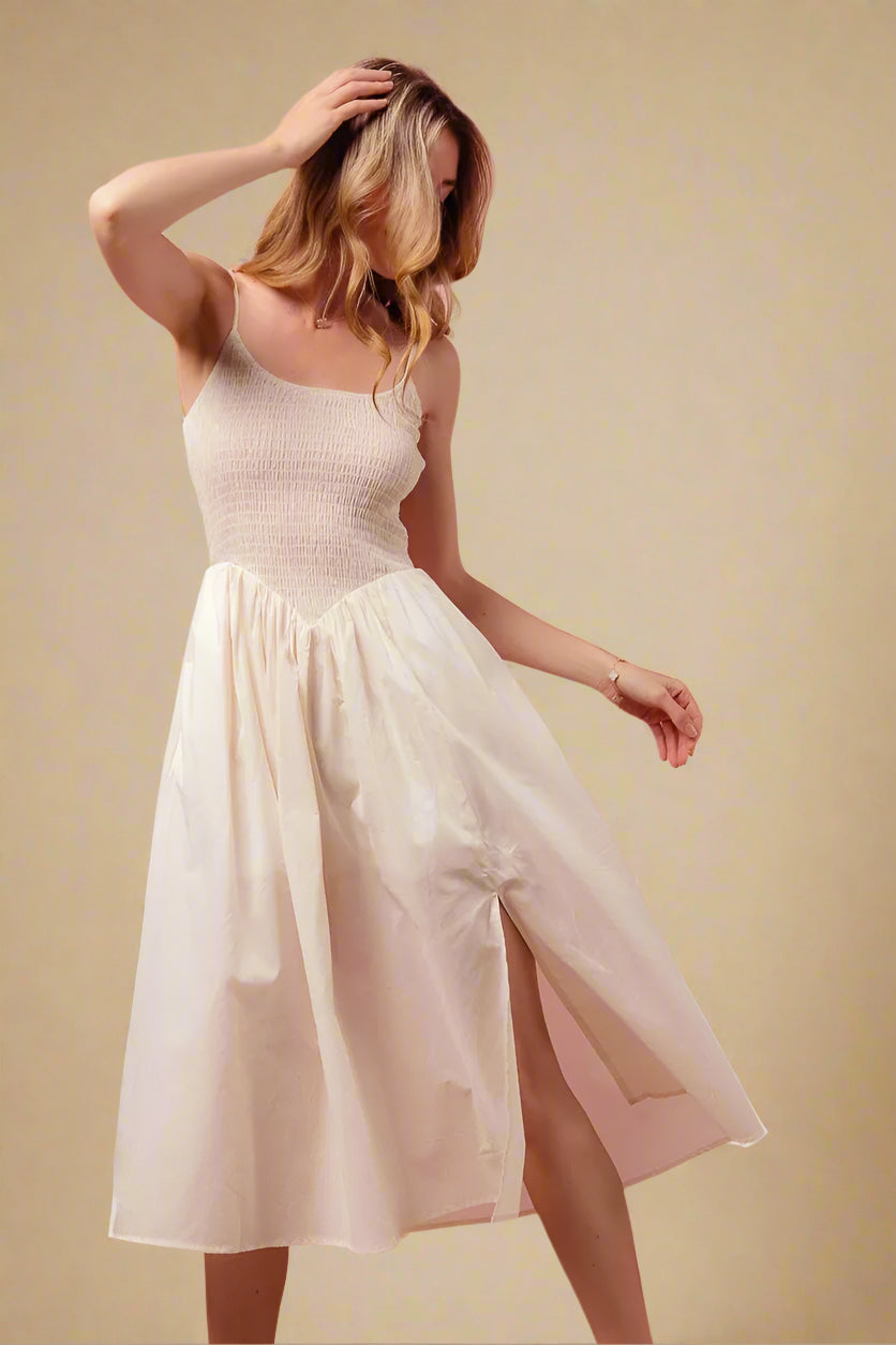 Woman wearing a white dress against a beige background