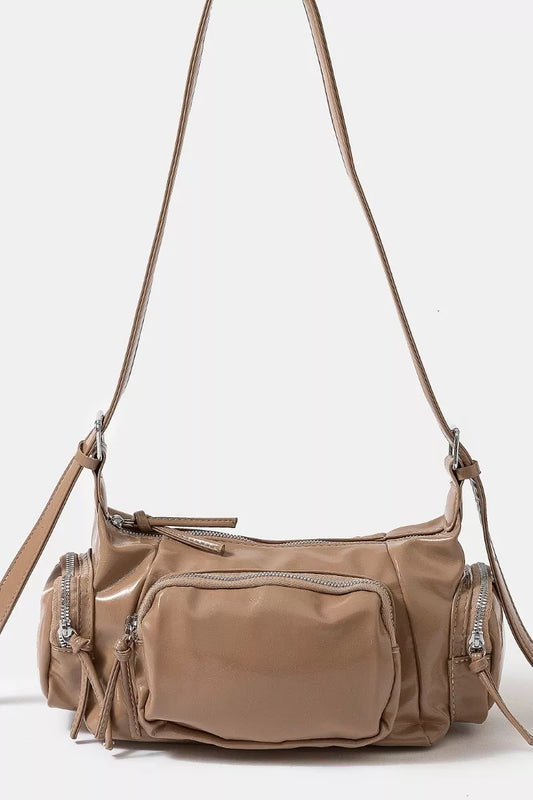 Brown shoulder bag with multiple pockets and zippers on a white background