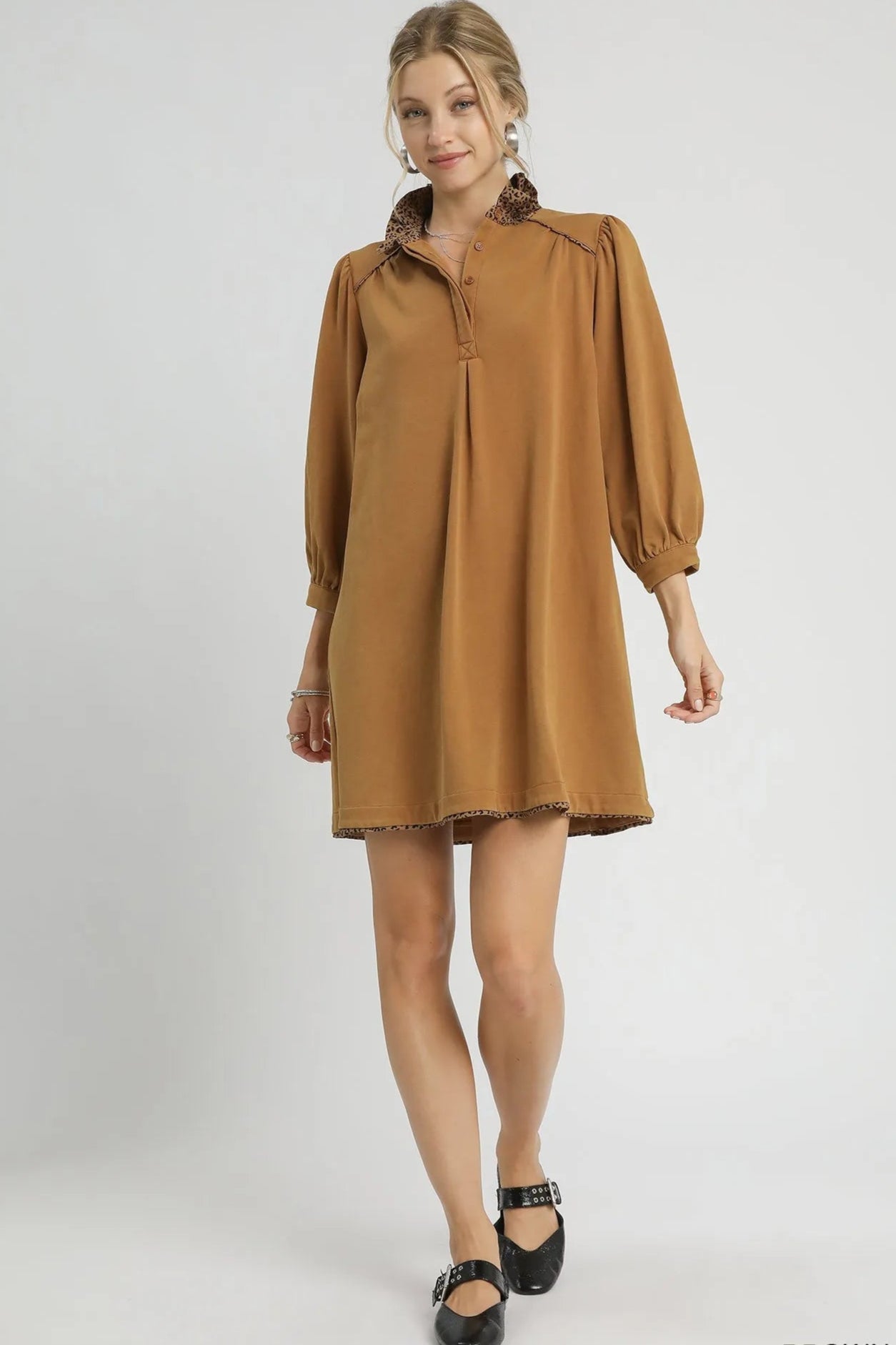 Woman wearing a brown dress on a white background